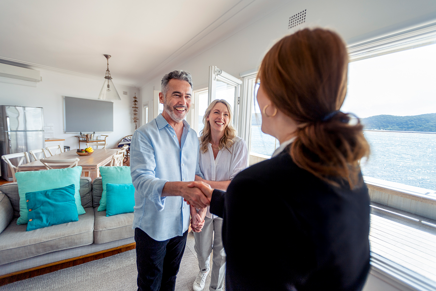 Couple shaking hands with realtor